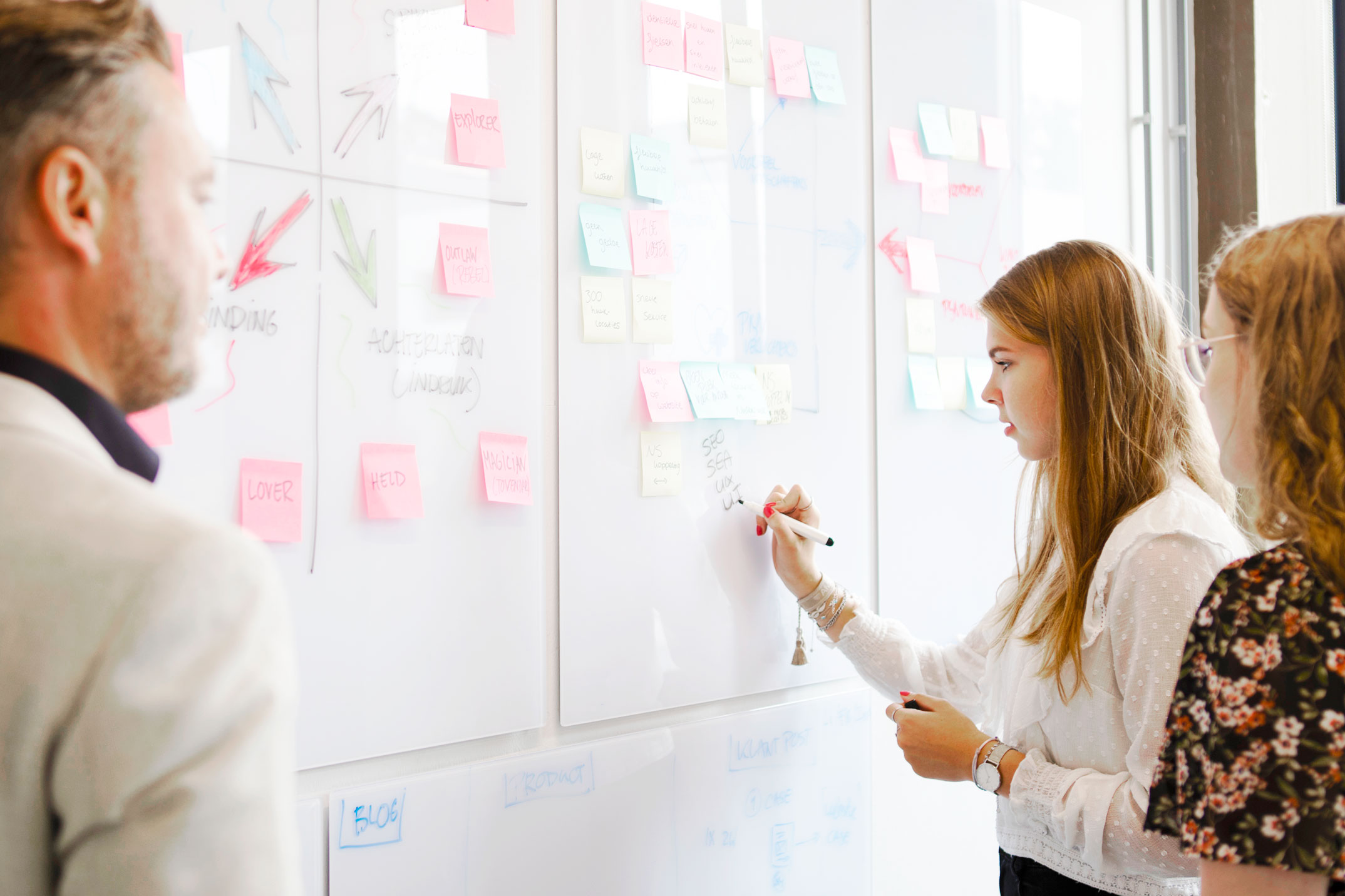 een man die een vrouw iets op een whiteboard toont
